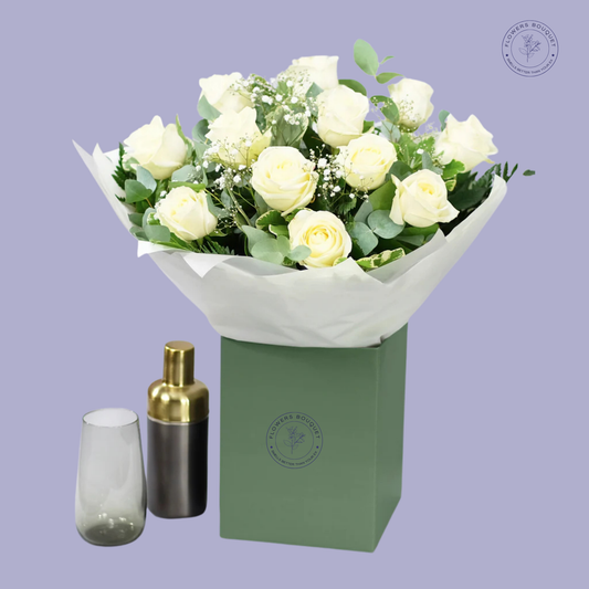 Classic White Elegance bouquet featuring white roses, baby’s breath, and eucalyptus leaves in a green gift box.