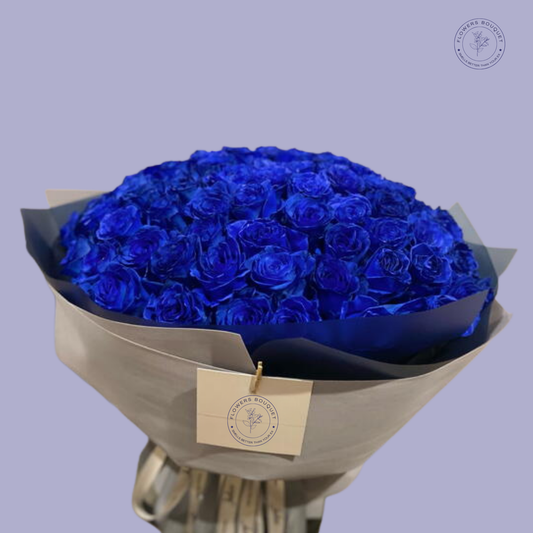 Midnight Elegance Bouquet with 100 royal blue roses, elegantly wrapped in premium grey paper with a satin ribbon.